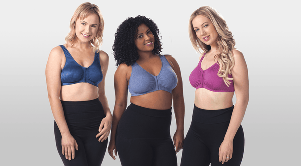 Three women standing next to each other wearing bras and leggings