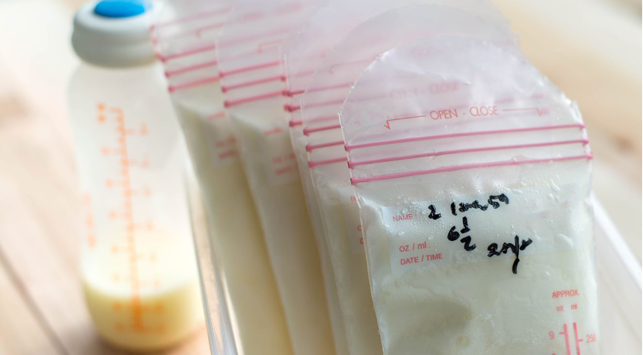 bagged breastmilk packets and baby bottle
