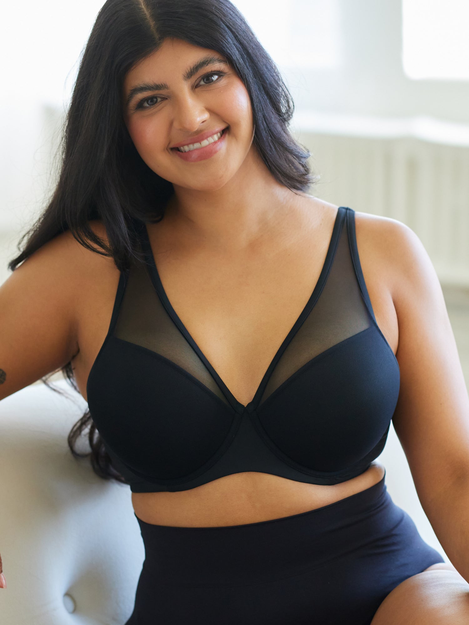 Lifestyle view of mesh plunge underwire bra in black