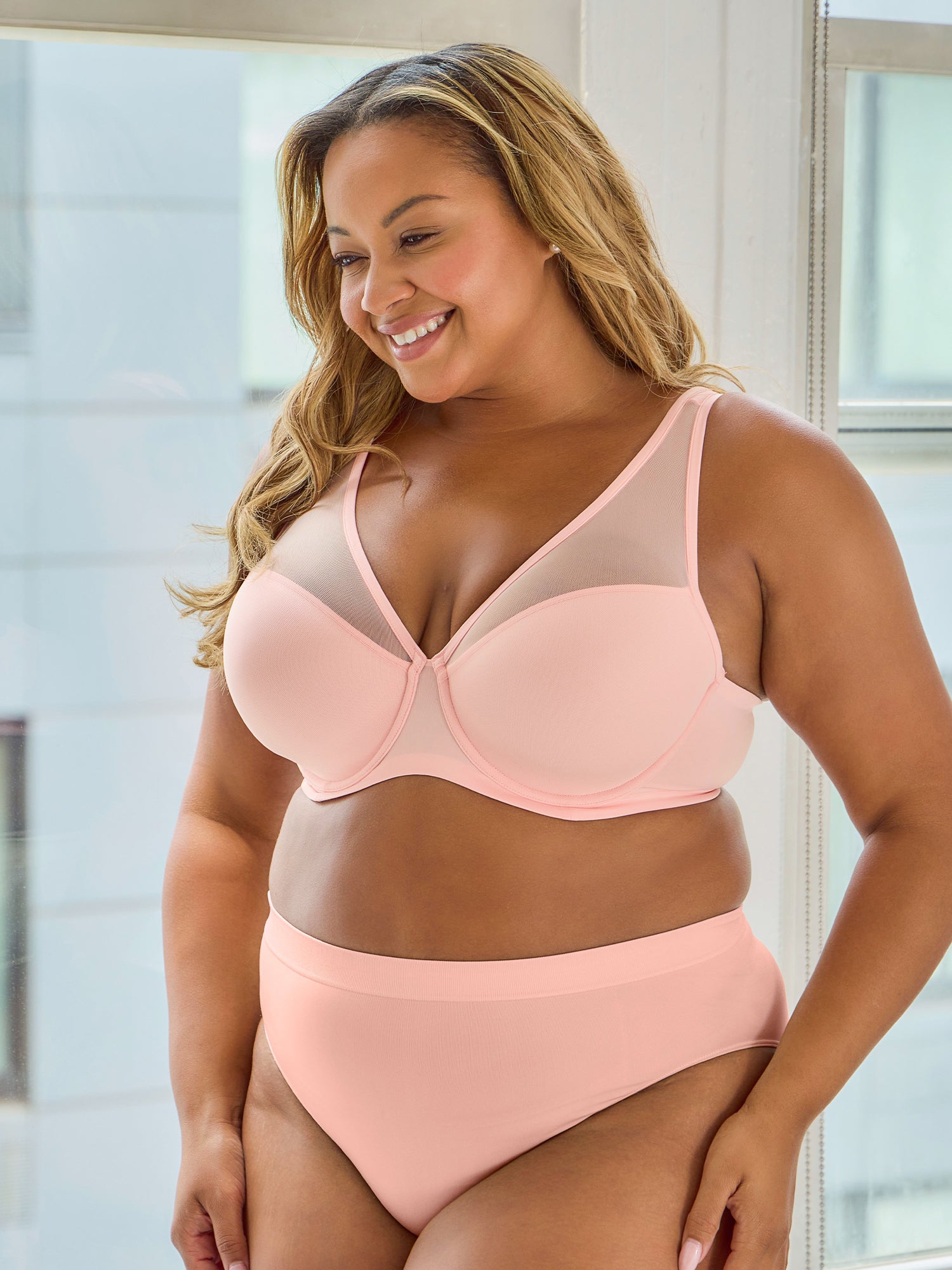 Lifestyle view of mesh plunge underwire bra in light pink