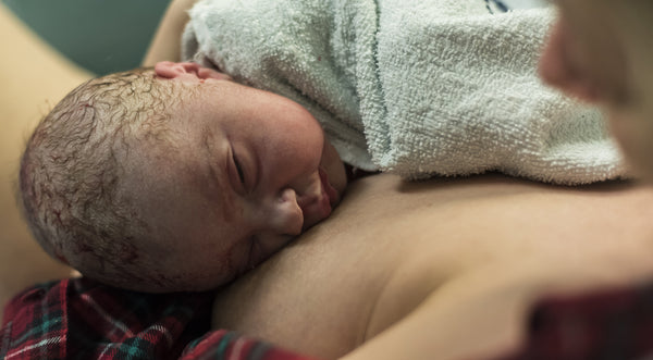newborn baby laying on mothers chest