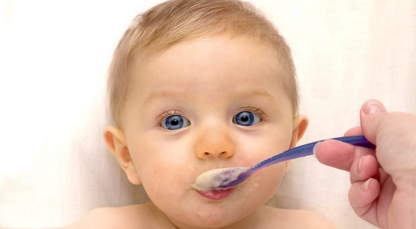 Close-up image of a baby being fed