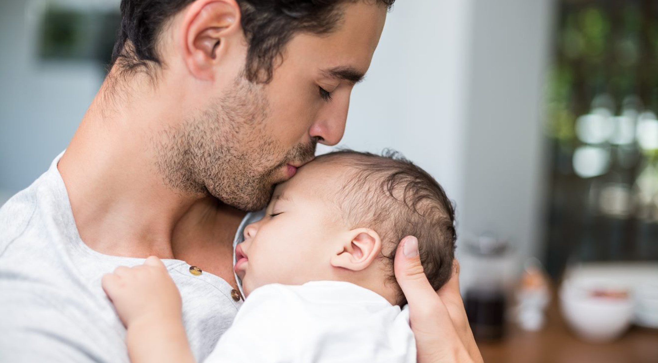 Man Kissing a Baby on the Forehead