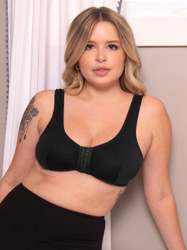 Woman posing in a black front-closure comfort bra