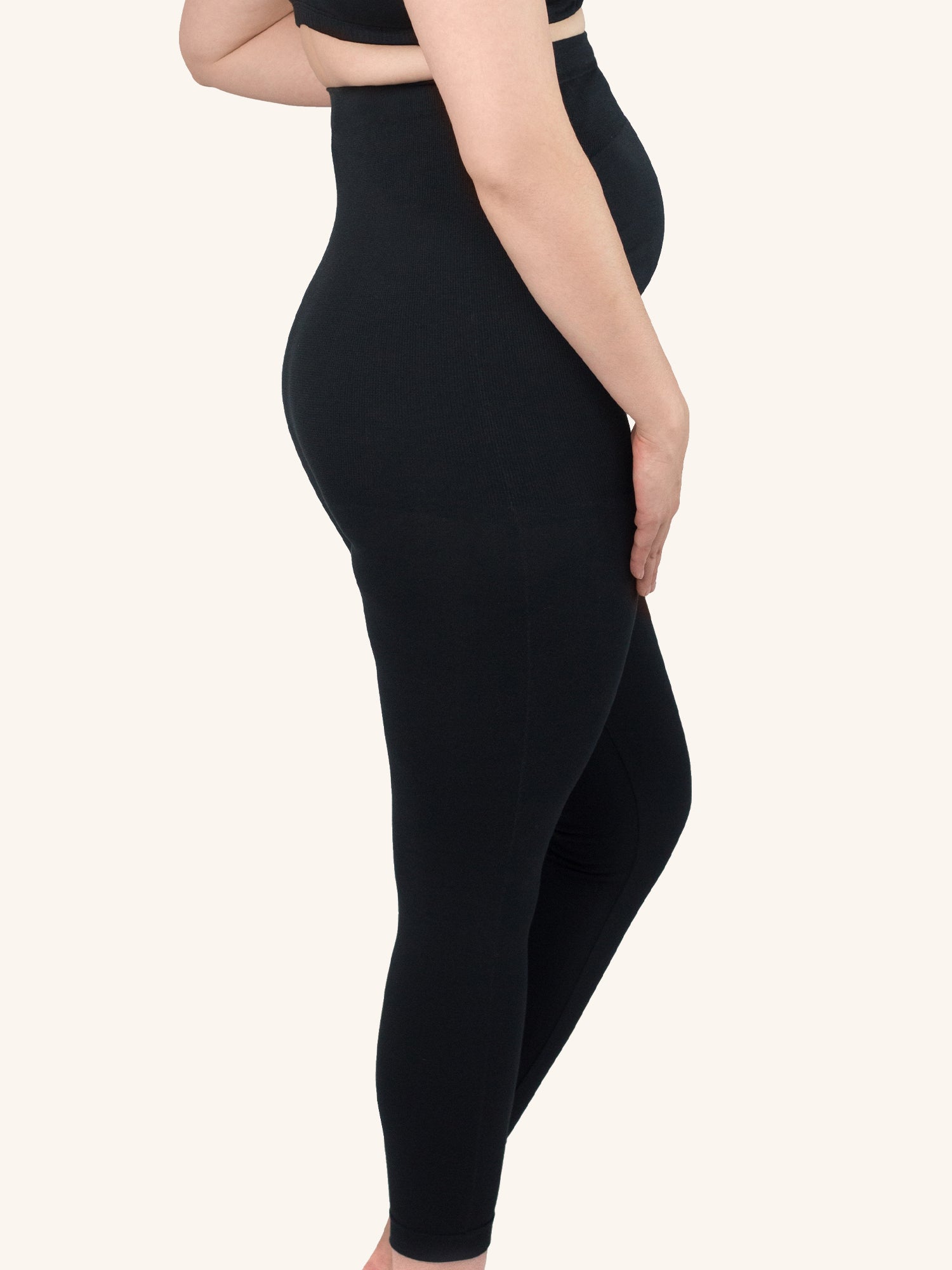 Side view of maternity jeggings in jet black