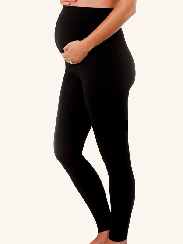 Side full-body view of maternity support leggings patented back support in jet black