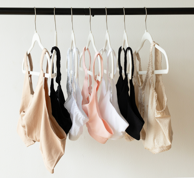 Different colored comfort bras on hangers